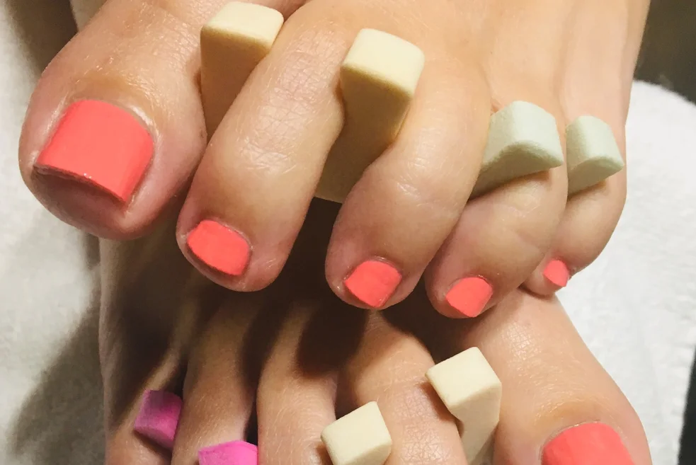 Pedicure with coral polish
